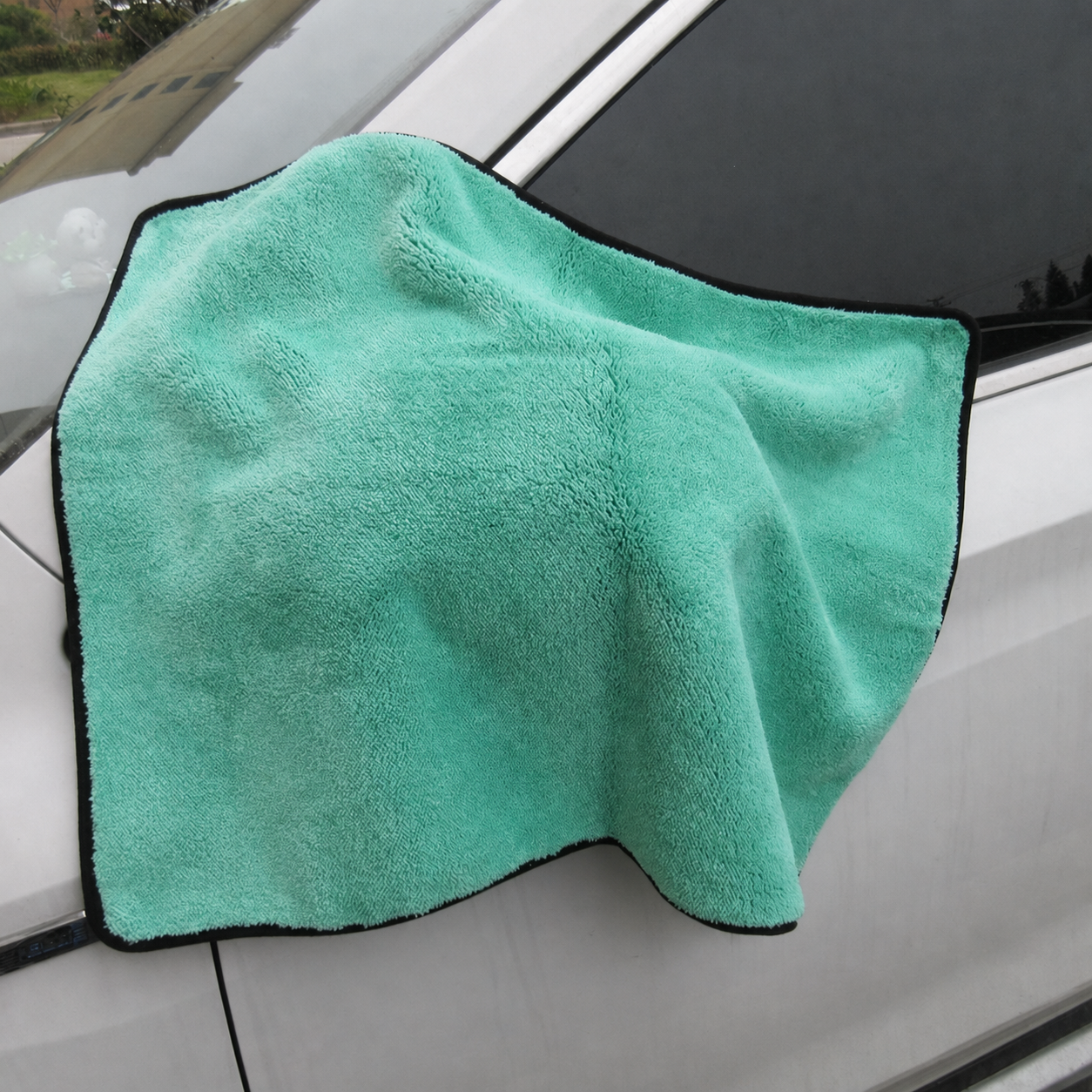 Emerald Green coral fleece car drying towel on a vehicle